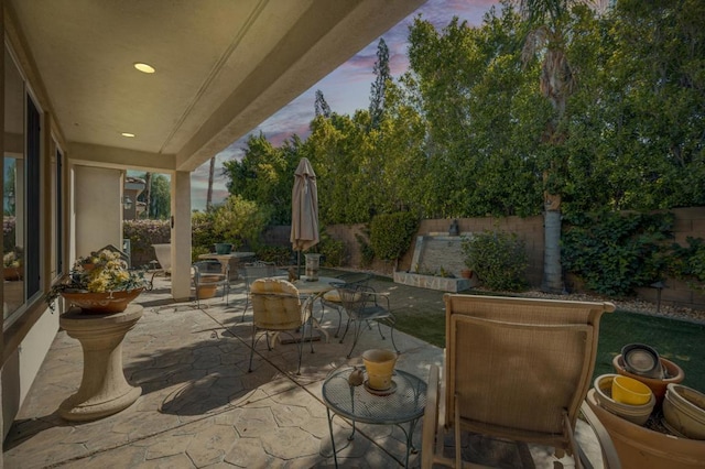 view of patio terrace at dusk