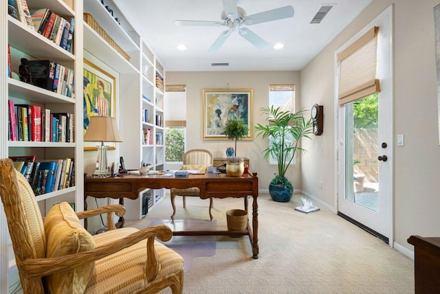 office area featuring ceiling fan and light carpet