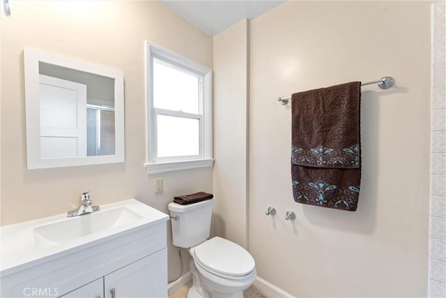 bathroom featuring vanity, toilet, and a shower