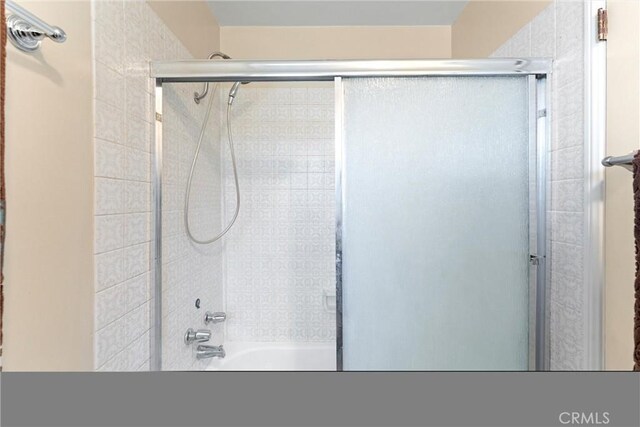 bathroom featuring shower / bath combination with glass door