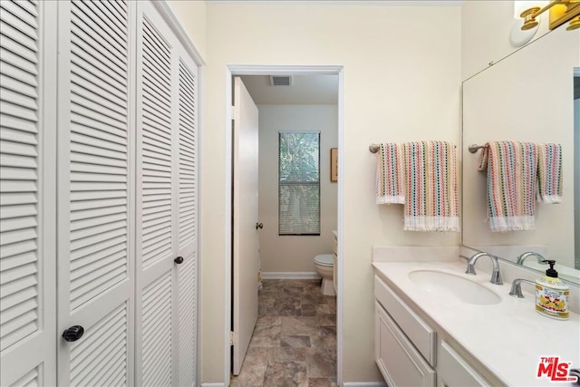 bathroom with vanity and toilet