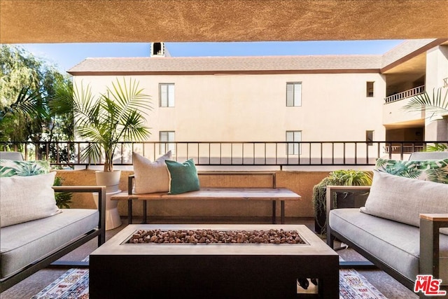 view of patio / terrace featuring an outdoor living space with a fire pit