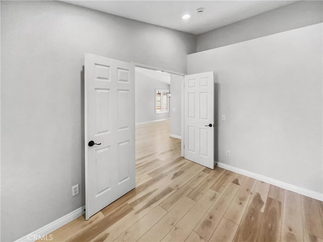 unfurnished room with light wood-type flooring