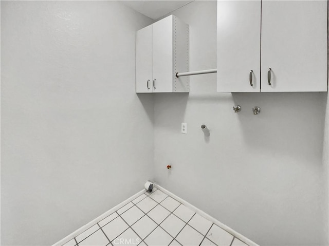 clothes washing area with cabinets, hookup for an electric dryer, gas dryer hookup, and washer hookup