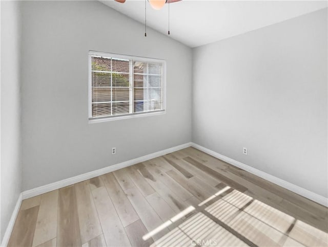 unfurnished room featuring ceiling fan, light wood-type flooring, and lofted ceiling