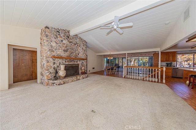 unfurnished living room with vaulted ceiling with beams, a stone fireplace, visible vents, and a ceiling fan