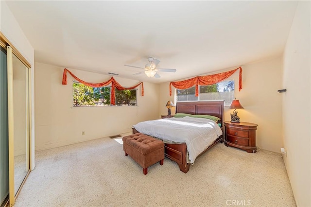 bedroom featuring multiple windows, ceiling fan, and visible vents