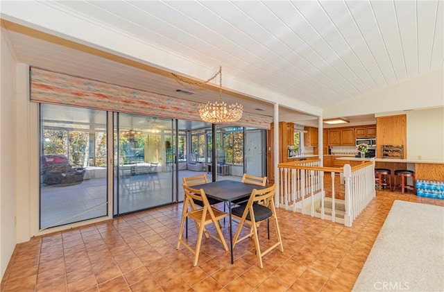 dining space featuring lofted ceiling, light tile patterned flooring, and a notable chandelier