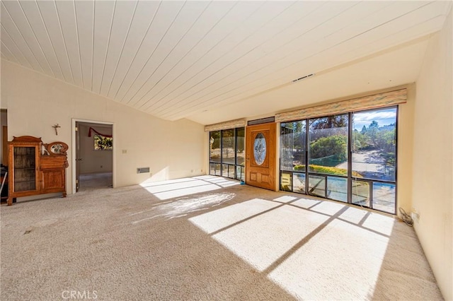 unfurnished living room featuring carpet floors, wooden ceiling, and vaulted ceiling