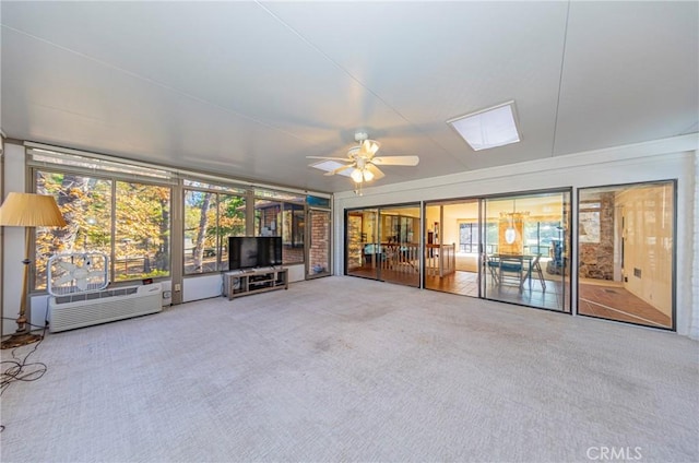 unfurnished living room featuring carpet, ceiling fan, and a wall mounted AC