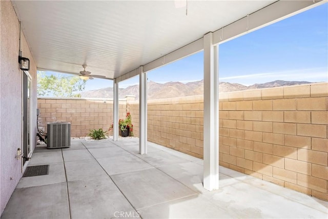 view of patio / terrace with a mountain view, central AC unit, and ceiling fan