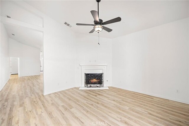 unfurnished living room with light wood-type flooring and ceiling fan