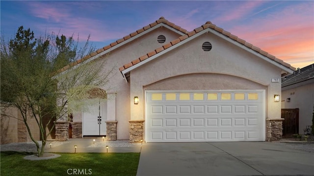 mediterranean / spanish-style house with a garage