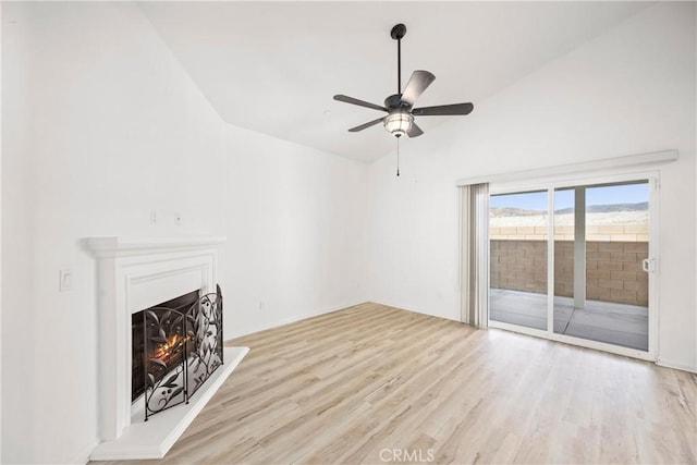 unfurnished living room featuring ceiling fan, vaulted ceiling, and light hardwood / wood-style flooring