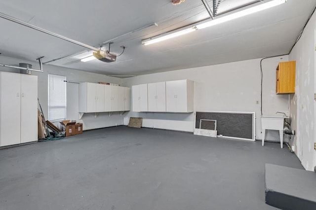 garage with a garage door opener and sink