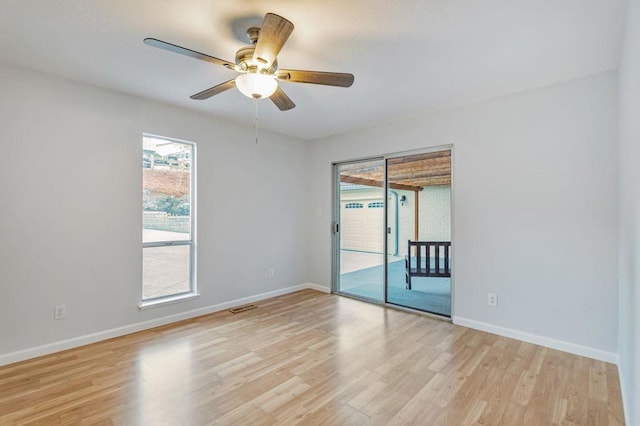 empty room with ceiling fan and light wood-type flooring