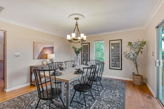 dining space featuring an inviting chandelier, crown molding, and a wealth of natural light