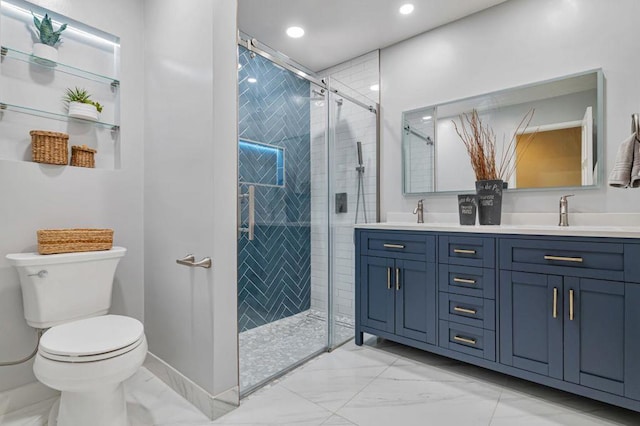 bathroom with a shower with door, vanity, and toilet