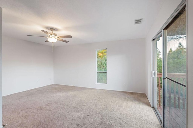 unfurnished room with ceiling fan and carpet