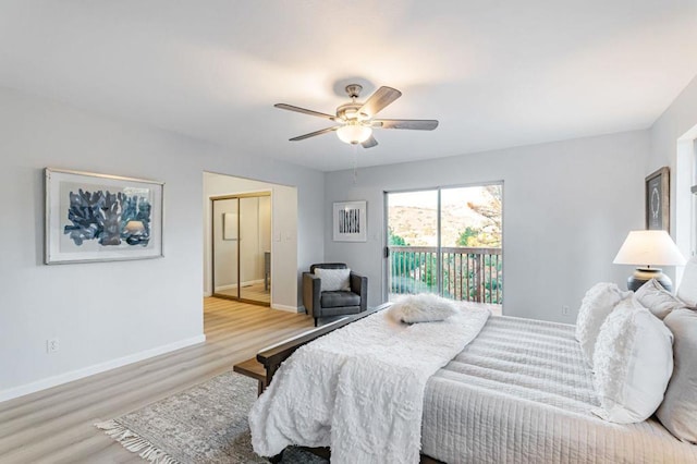 bedroom featuring light hardwood / wood-style flooring, access to outside, a closet, and ceiling fan