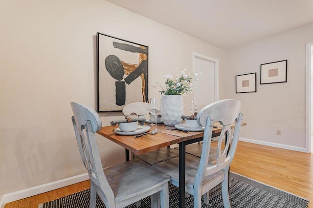 dining area with hardwood / wood-style flooring