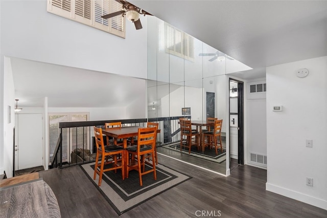 dining area featuring ceiling fan and dark wood-type flooring