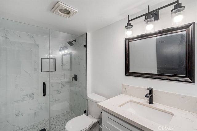 bathroom featuring vanity, toilet, and an enclosed shower