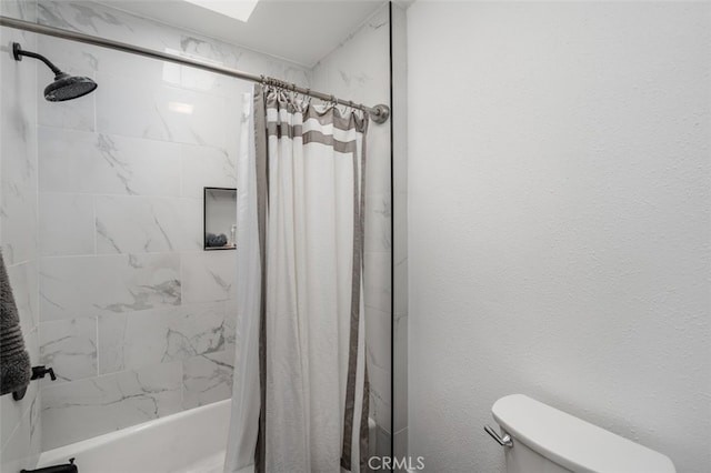 bathroom featuring toilet and shower / tub combo with curtain