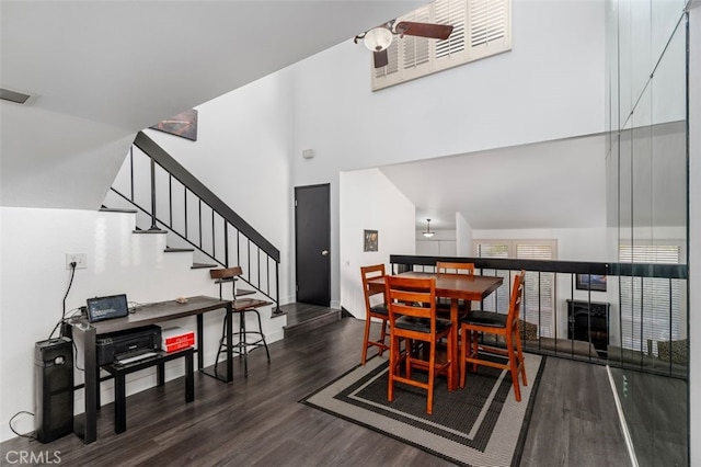 dining room featuring high vaulted ceiling and dark hardwood / wood-style floors