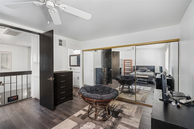 office with ceiling fan and dark wood-type flooring