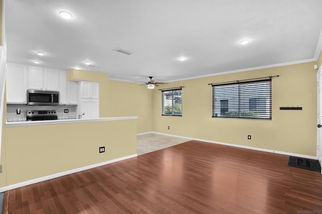 unfurnished living room with light hardwood / wood-style floors, ceiling fan, and crown molding