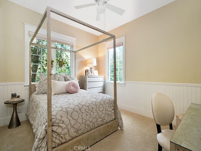 bedroom with ceiling fan and light colored carpet