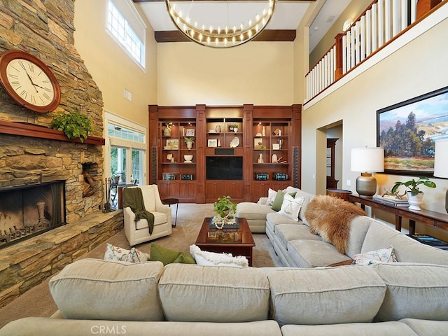 living room with a towering ceiling, a fireplace, and a chandelier