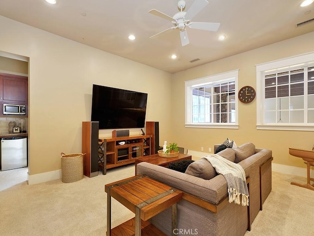 living room featuring light carpet and ceiling fan