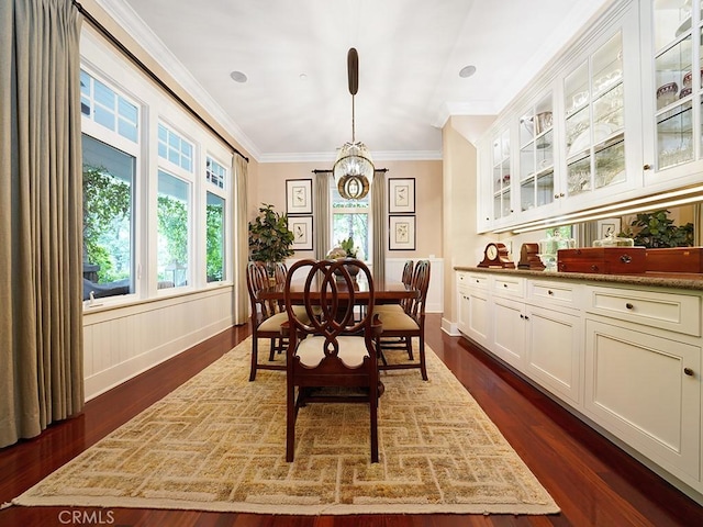 dining space featuring crown molding and dark hardwood / wood-style flooring