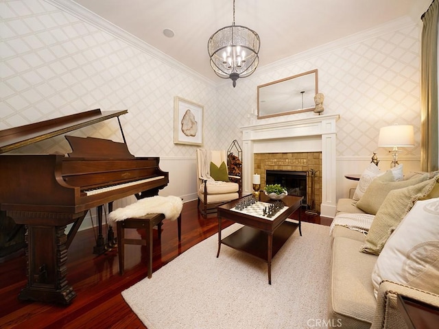 sitting room with a notable chandelier, dark hardwood / wood-style flooring, and ornamental molding