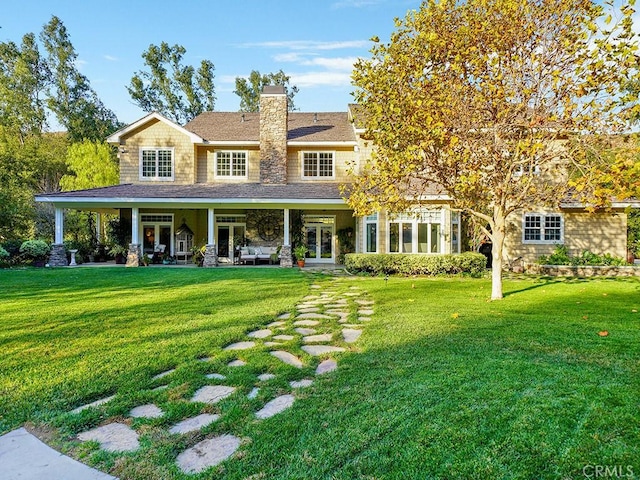 back of house featuring a yard