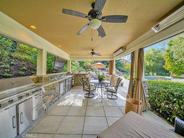 view of patio featuring ceiling fan, area for grilling, sink, and grilling area