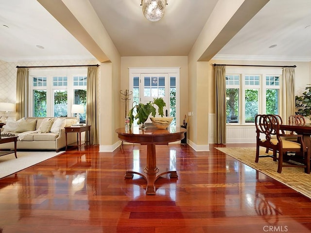 entryway featuring wood-type flooring and ornamental molding