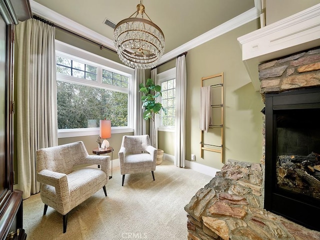 sitting room featuring light colored carpet, a stone fireplace, ornamental molding, and a notable chandelier