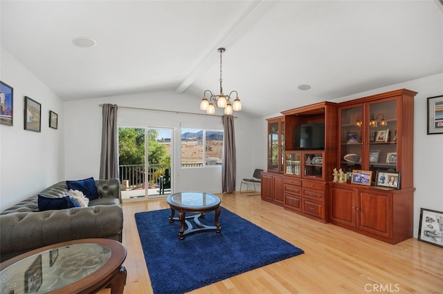 living room with vaulted ceiling with beams, light hardwood / wood-style floors, and an inviting chandelier