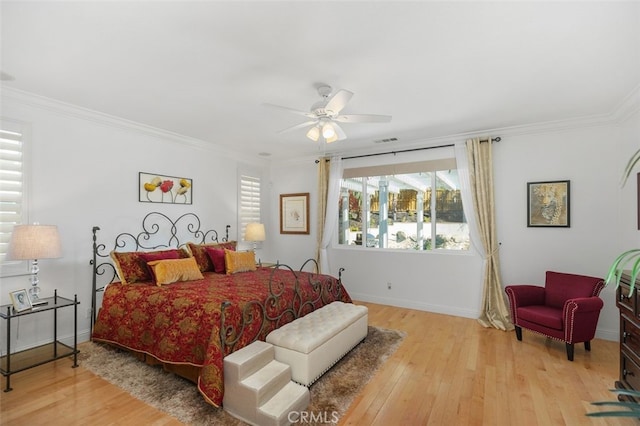 bedroom with ceiling fan, light hardwood / wood-style floors, and ornamental molding