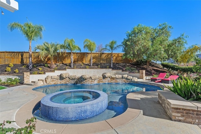 view of pool with a patio area and an in ground hot tub