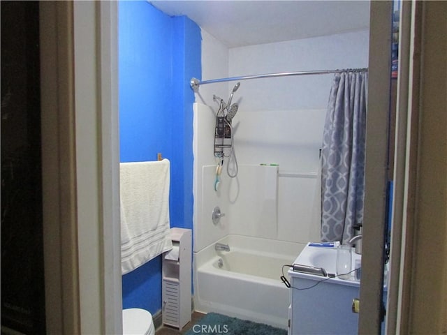 full bathroom featuring shower / bath combo, vanity, and toilet