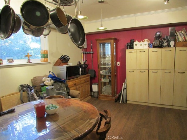 dining space featuring dark hardwood / wood-style flooring and crown molding