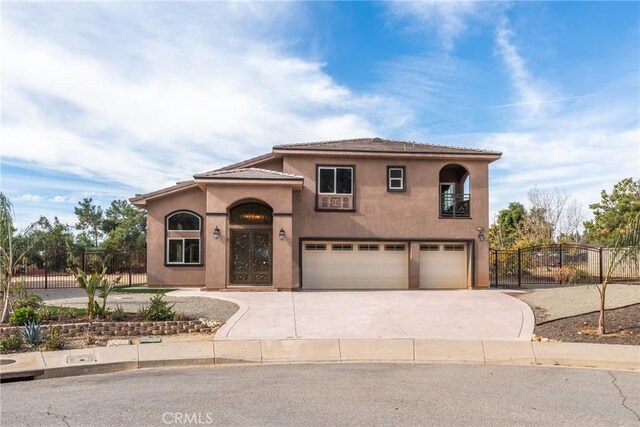 mediterranean / spanish house featuring a garage