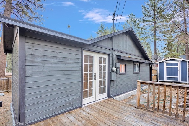 wooden deck featuring french doors and a shed