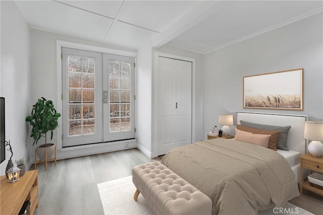 bedroom with french doors, a closet, access to exterior, and light hardwood / wood-style flooring