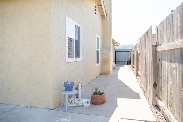 view of side of home with a patio