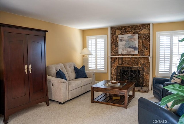 living room featuring a fireplace and light carpet